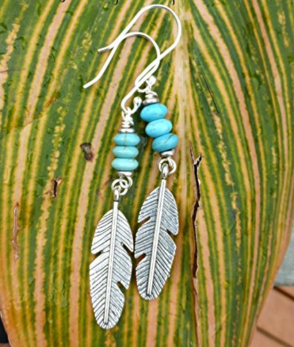 Silver metal feather charms, Turquoise howlite stone earrings. Handmade bohemian, boho, southwest, jewelry, jewellery. Long, lightweight earrings. Sterling silver ear wires. Fashion, Accessories.