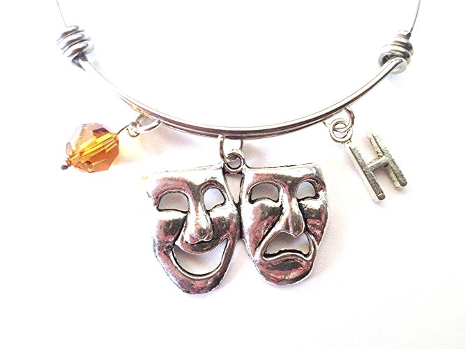 Comedy and tragedy mask themed personalized bangle bracelet. Antique silver charms and a genuine Swarovski birthstone colored element.