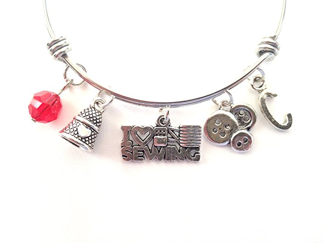 Sewing themed personalized bangle bracelet. Antique silver charms and a genuine Swarovski birthstone colored element.
