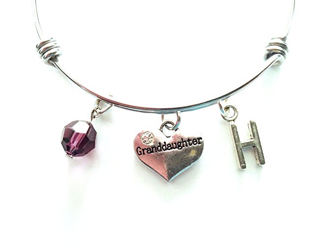 Granddaughter themed personalized bangle bracelet. Antique silver charms and a genuine Swarovski birthstone colored element.