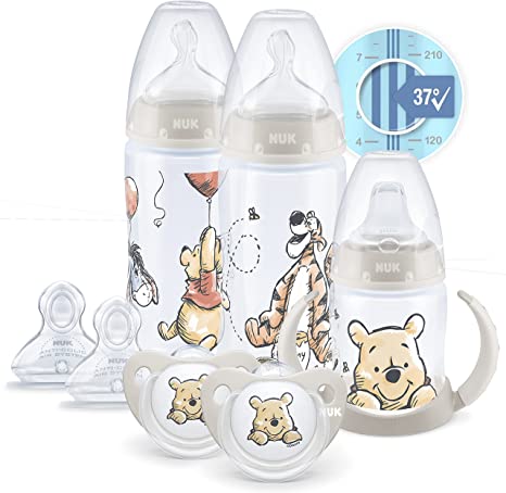 NUK Disney First Choice  First Years Set | 0  Months | Temperature Control | 2 x 300 ml Bottles, 1 x Learner Cup, 2 x Soothers, 2 Teats | Anti-colic Vent | BPA-Free | Winnie-the-Pooh | 7 Count