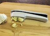 KOVOT Garlic Press and Slicer - Cleaning Tool Included - Made of Premium Cast Alloy with a Non Stick Coating