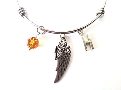 Angel wing themed personalized bangle bracelet. Antique silver charms and a genuine Swarovski birthstone colored element.