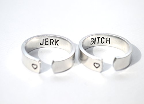 PAIR of aluminum adjustable rings bitch and jerk inside text